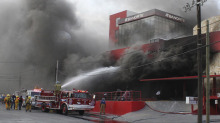 Firefighters try to extinguish a fire after an arson attack on a casino in Monterrey, Mexico. - Firefighters try to extinguish a fire after an arson attack on a casino in Monterrey, Mexico. | Victor Hugo Valdivia/Reuters