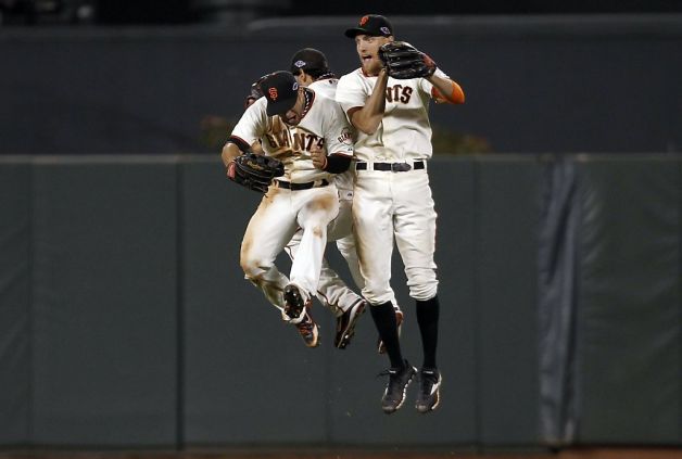 Gregor Blanco (left), Angel Pagan and Hunter Pence jump for joy after evening the NLCS. Photo: Michael Macor, The Chronicle / SF