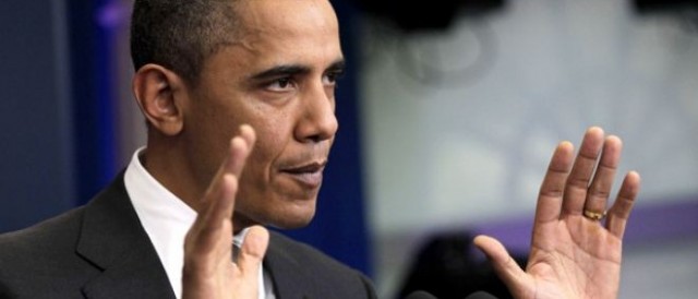 Obama gestures in defense. AP Images.